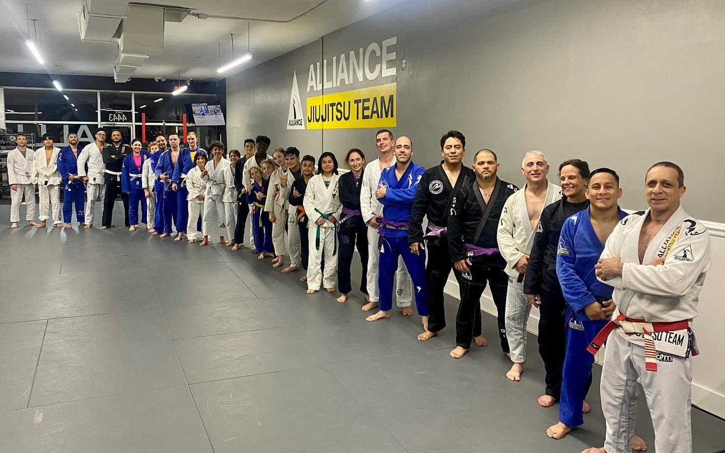 The adult Brazilian Jiu Jitsu team in their gis at Rollyson Brazilian Jiu Jitsu